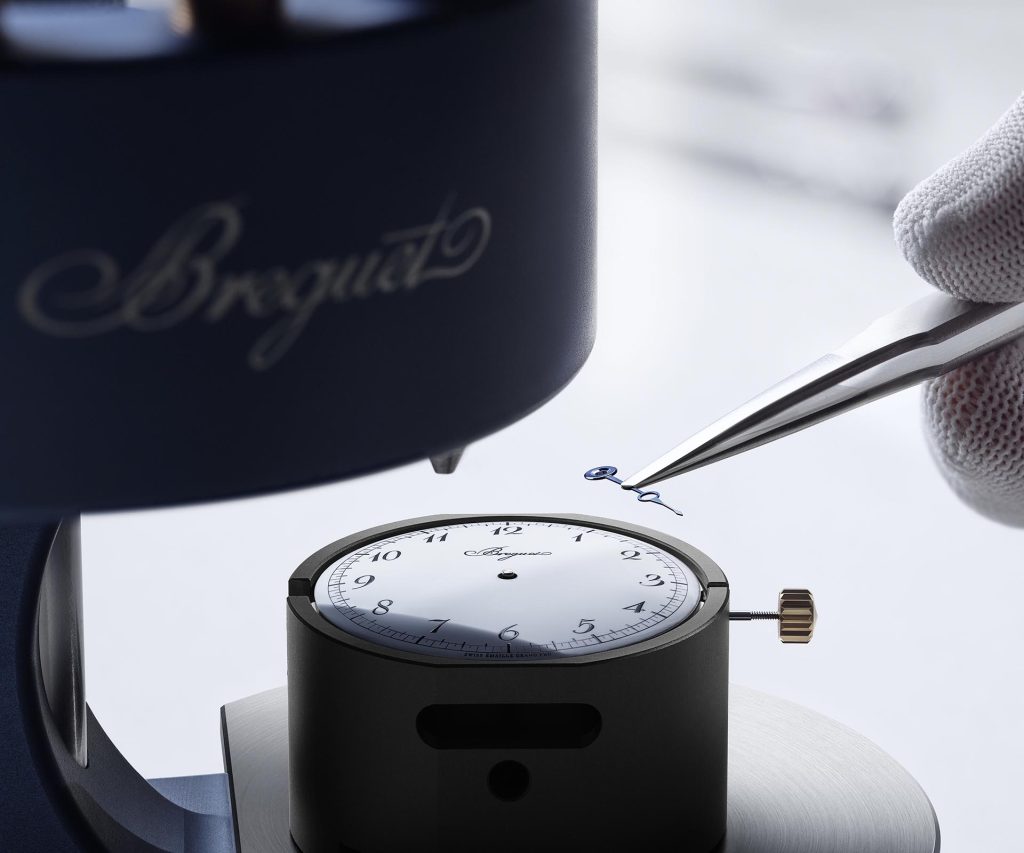 Close-up of Breguet Classique Souscription 2025 dial showing white grand feu enamel surface with black Breguet numerals, single blued steel hand, and minute track.