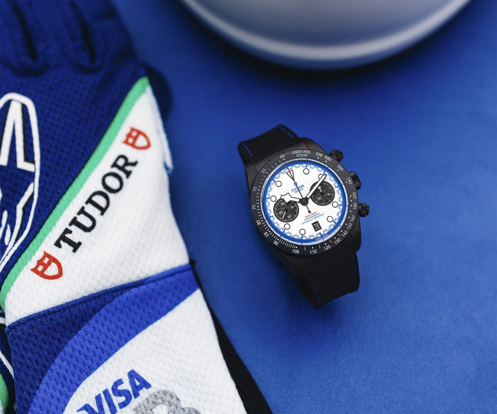 TUDOR Black Bay Chrono Carbon 25 displayed with blue Racing Bulls Formula One team equipment